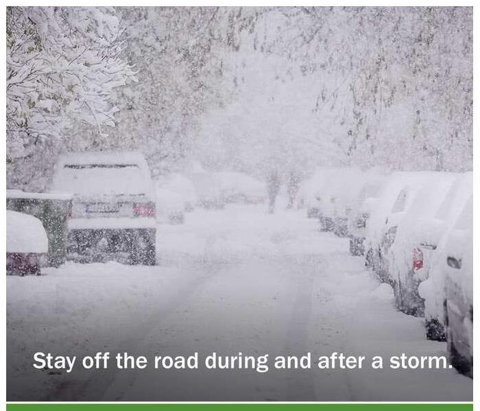 image of street during snow storm with lettering that says stay off the road before and after a storm