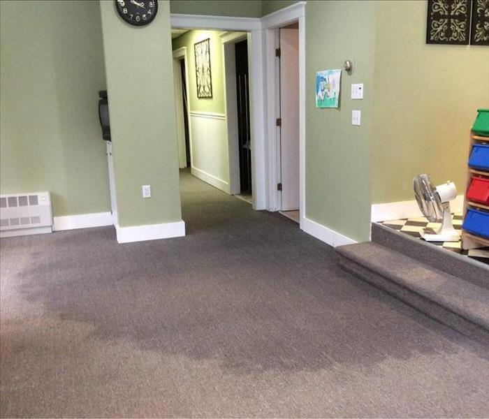 Hair salon office with water damage on carpet